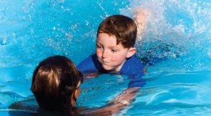 private lesson boy learning to swim one-on-one