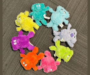 Dovercat stuffed characters in different colours in a circle