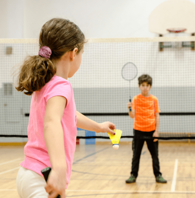 two kids playing badminton